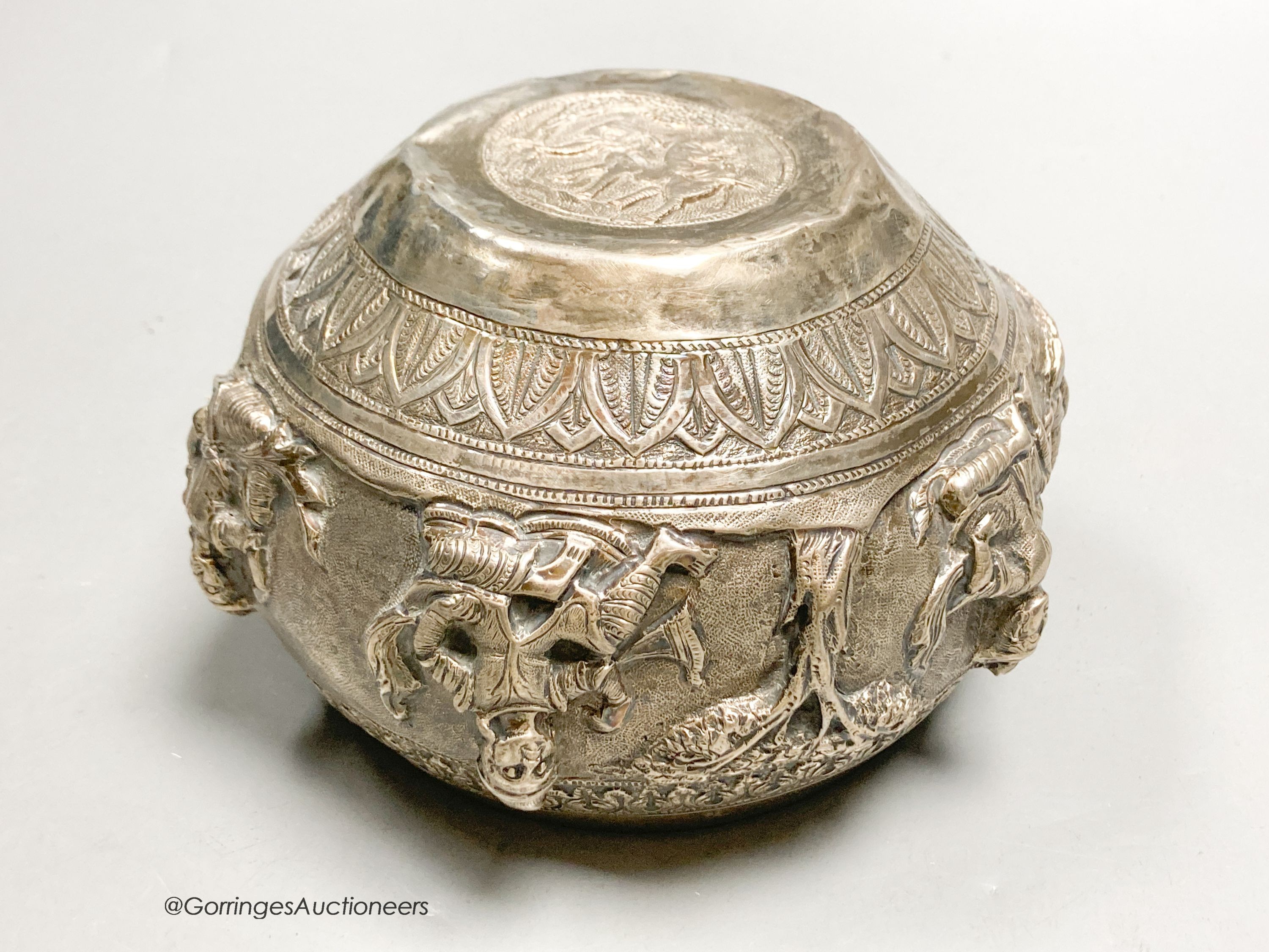 An Indian embossed white metal bowl, decorated with deities, height 8.5cm, 9oz.